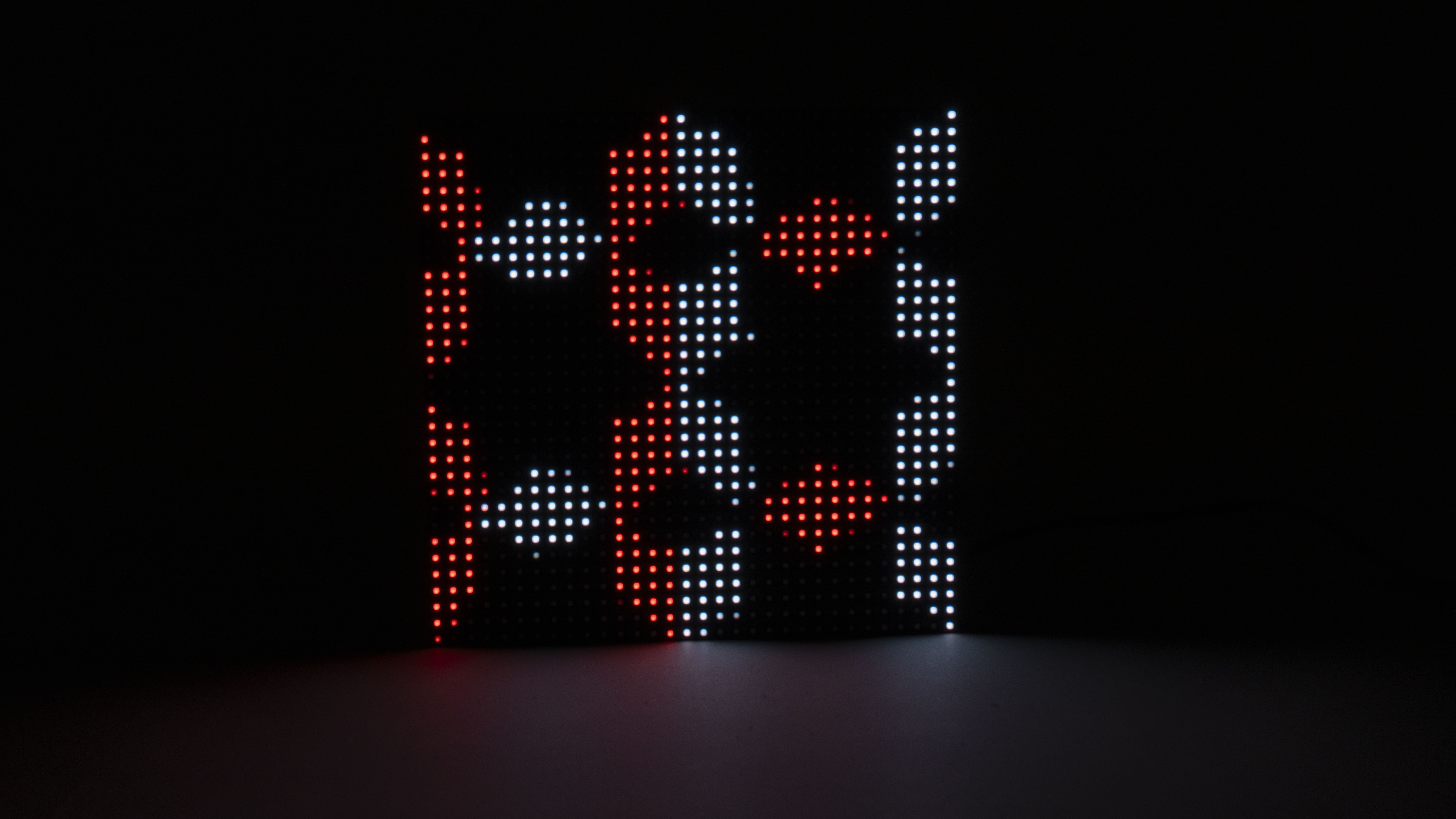 LED matrix with mirrored red and white geometric patterns